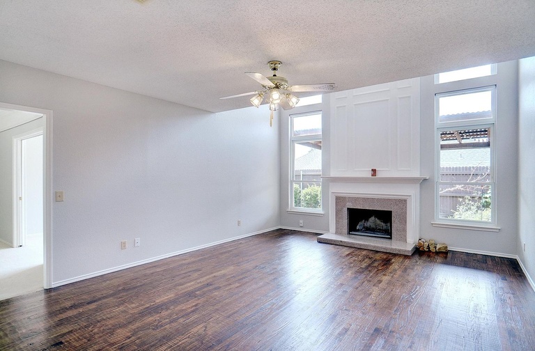 Empty living room with fireplace before staging
